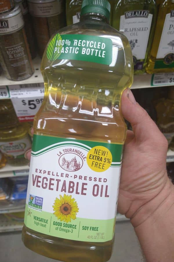 Holding a bottle of La Tourangelle Expeller-Pressed Vegetable Oil