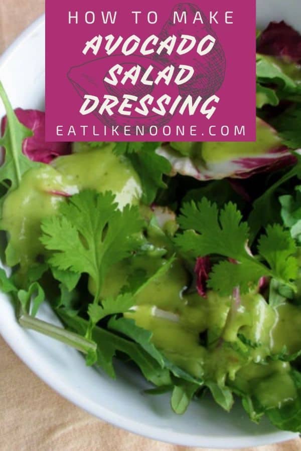 A salad made of mixed green and cilantro in a bowl with avocado salad dressing on top. A maroon box at the top has the words "How to make avocado salad dressing" in it.