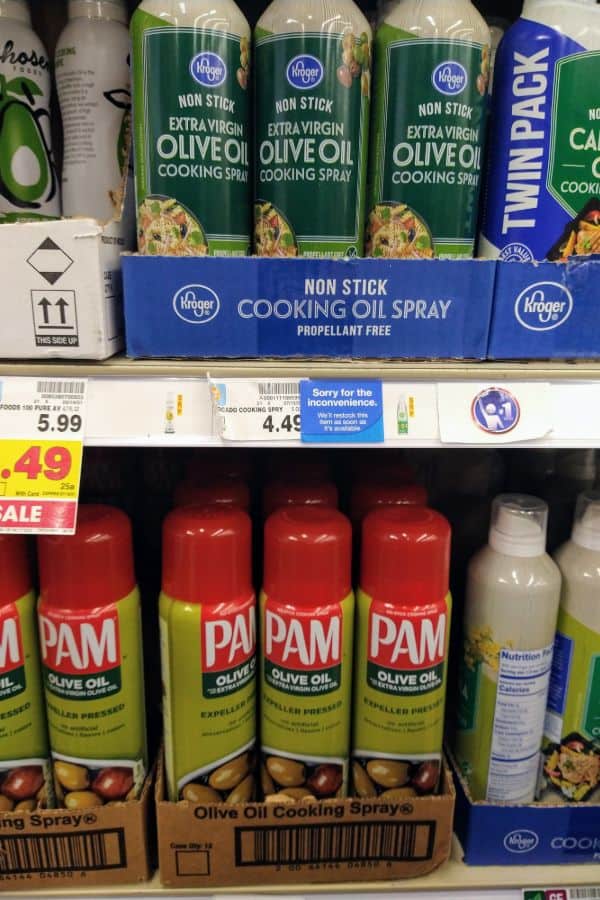 A grocery store display of olive oil cooking sprays.