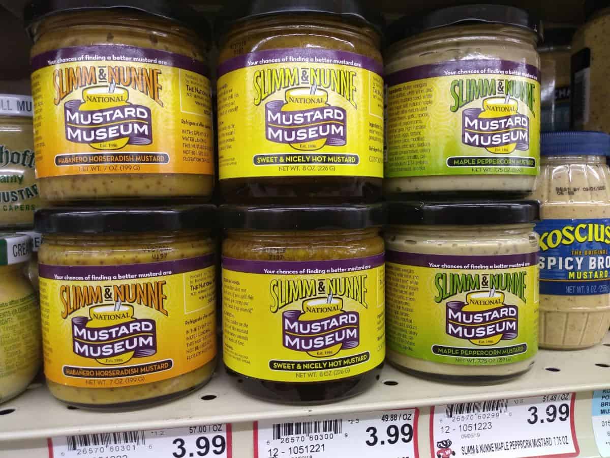 Slimm & Nunne National Mustard Museum mustard in jars are on shelves.
