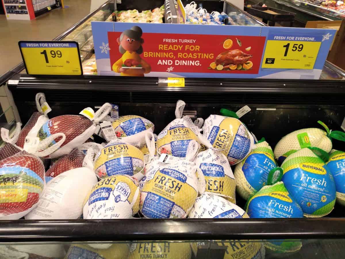 A display at a Kroger store featuring different brands of fresh turkeys