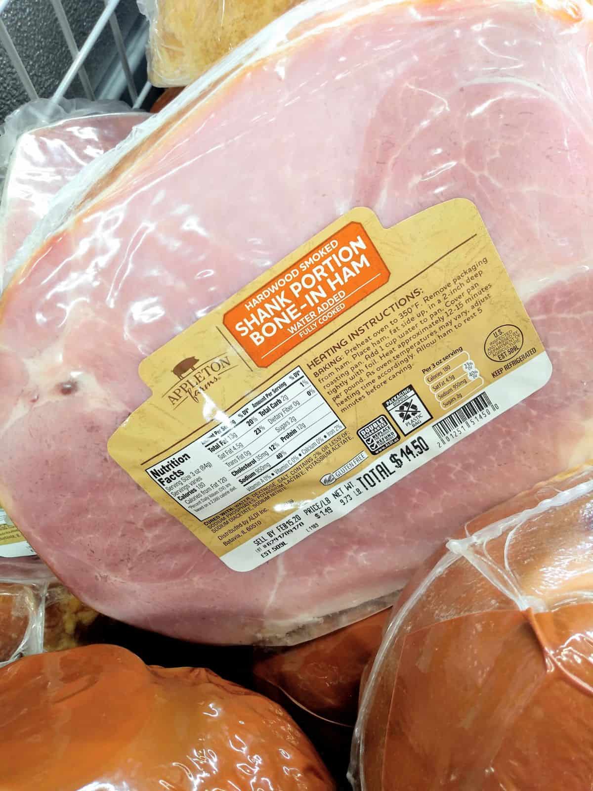 Appleton Farms Hardwood Smoked Shank Portion Bone-In Ham in it's packaging on display at ALDI