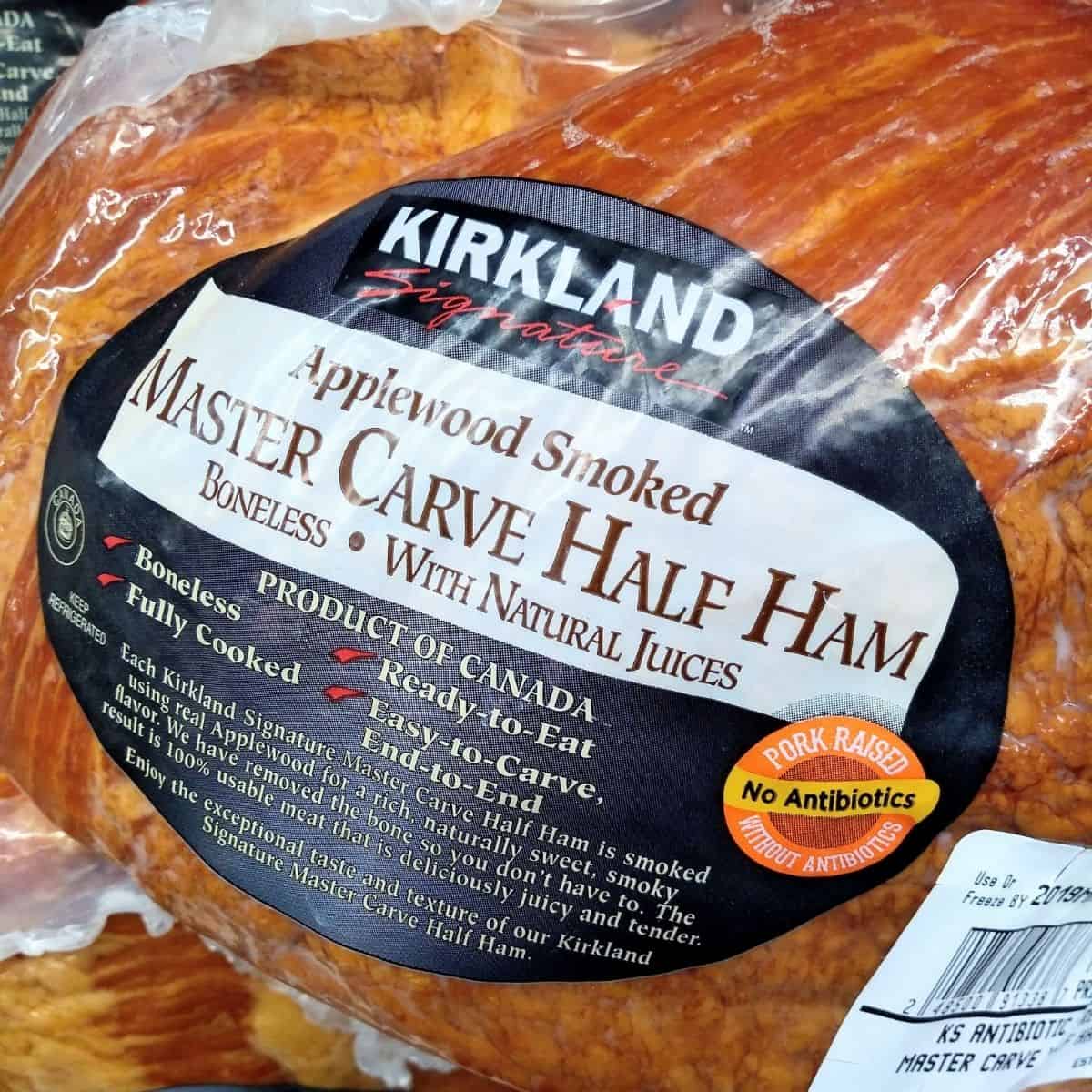 Close up of a package of Kirkland Brand Applewood Smoked Master Carve half Boneless Ham with Nature Juices. 