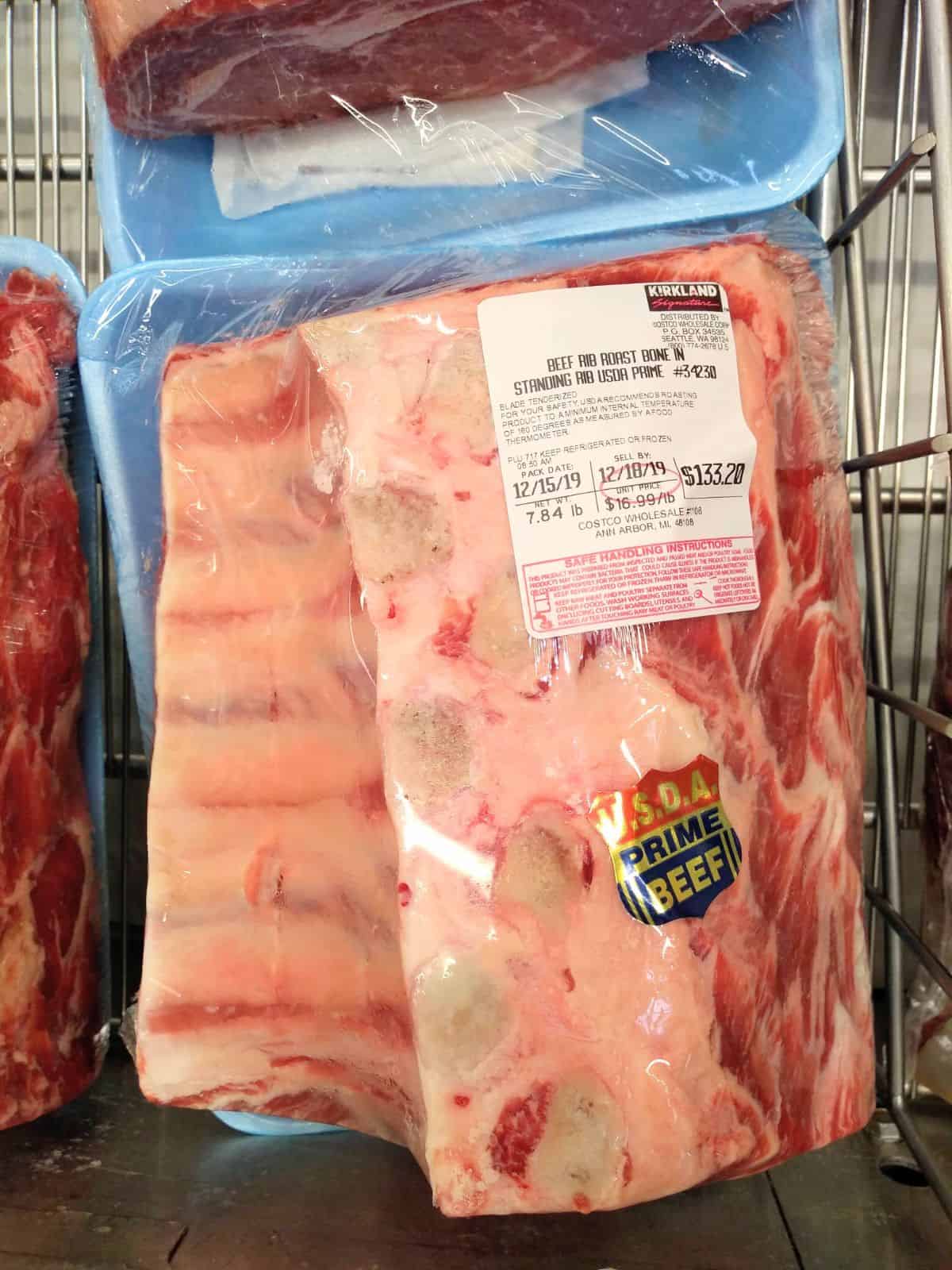 A packaged Kirkland brand bone-in USDA Prime Beef Standing Rib Roast at a Costco store.