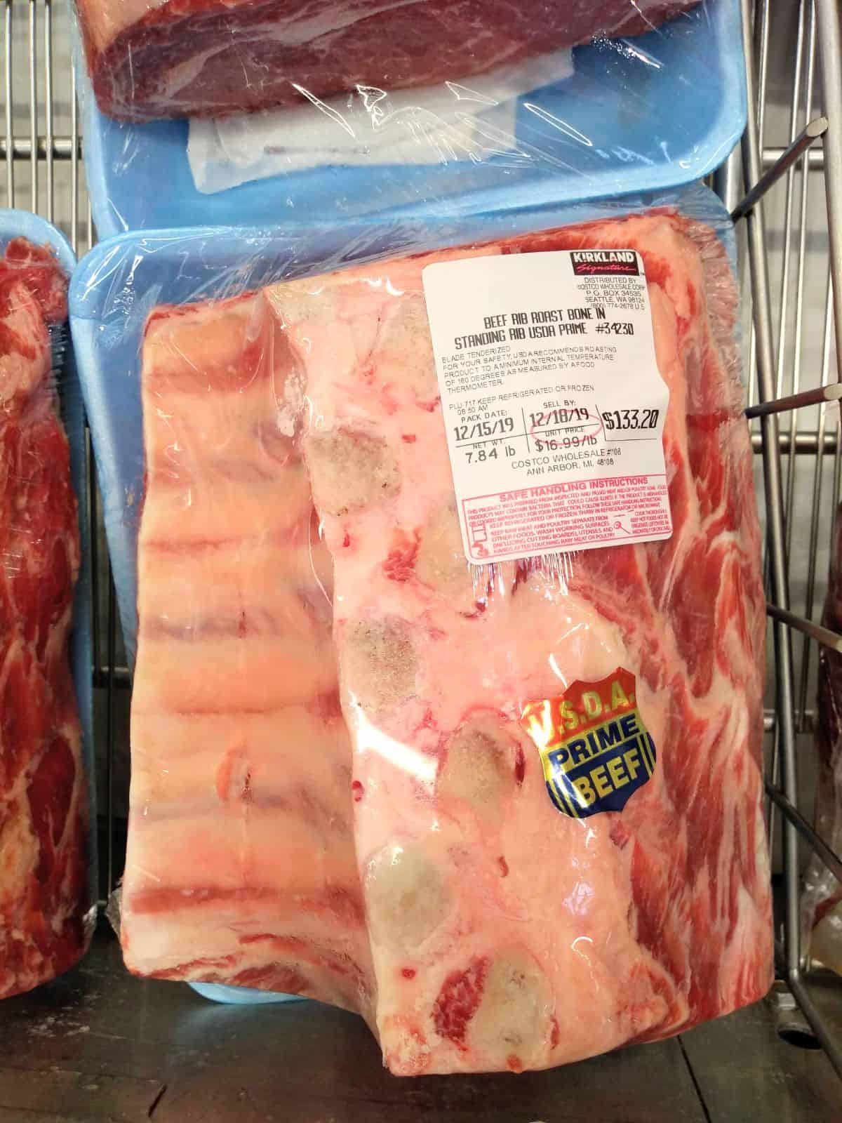 A packaged Kirkland brand bone-in USDA Prime Beef Standing Rib Roast at a Costco store.  