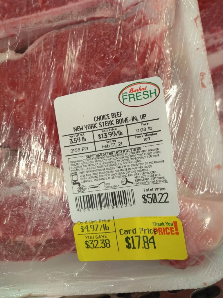 A package of Choice New York Strip bone-in steaks. The steaks are on sale for $4.97/lb.