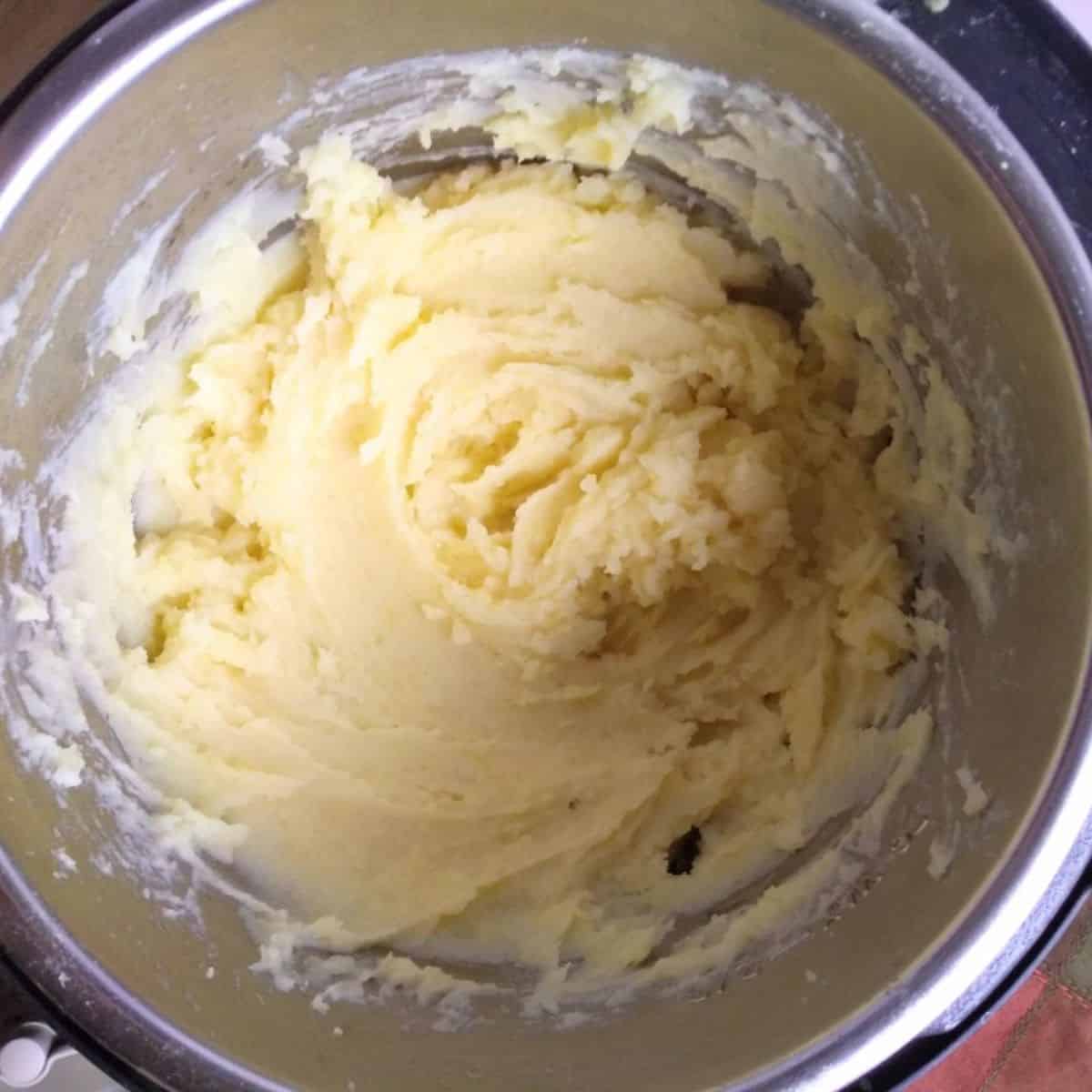 A bowl filled with mashed potatoes,