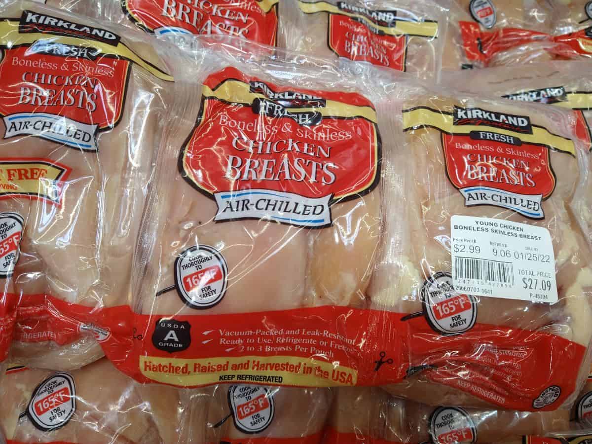 Kirkland Boneless Skinless Air Chilled chicken breasts in packaging in refrigerated display at Costco.