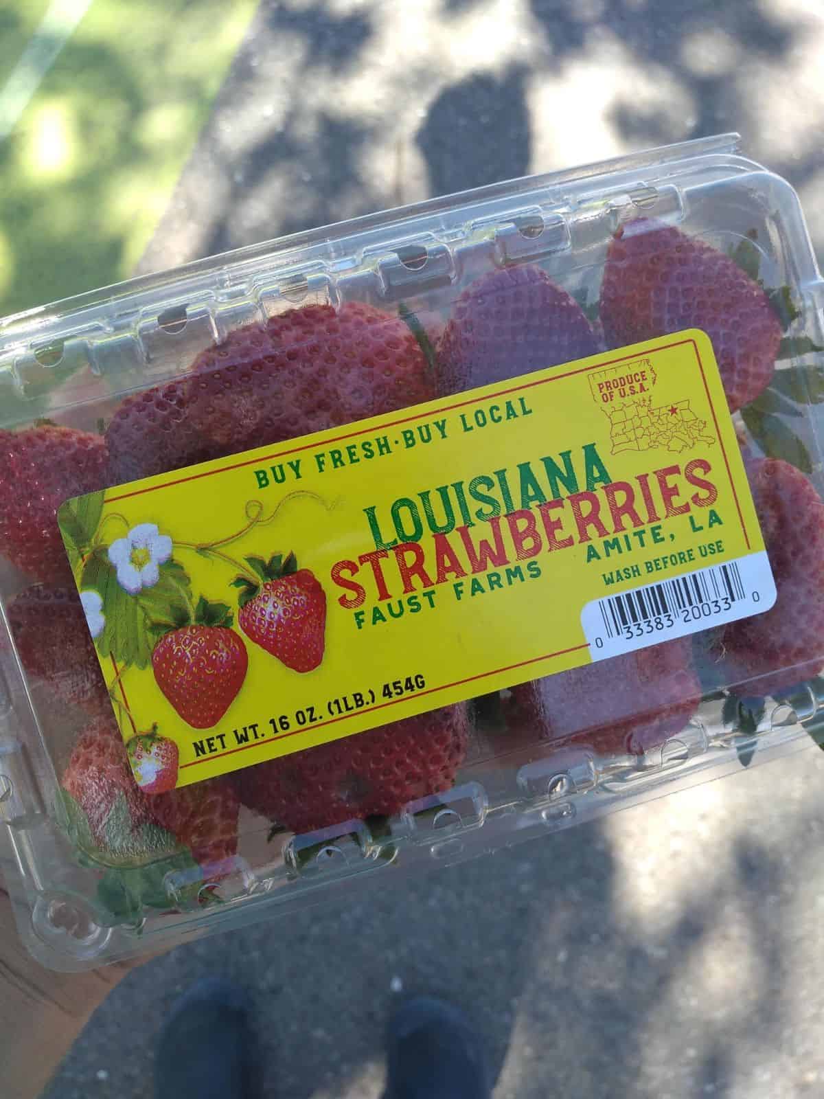 A plastic container of Louisiana Strawberries form Faust farms. Picture was taken at a farmer's market in April. 