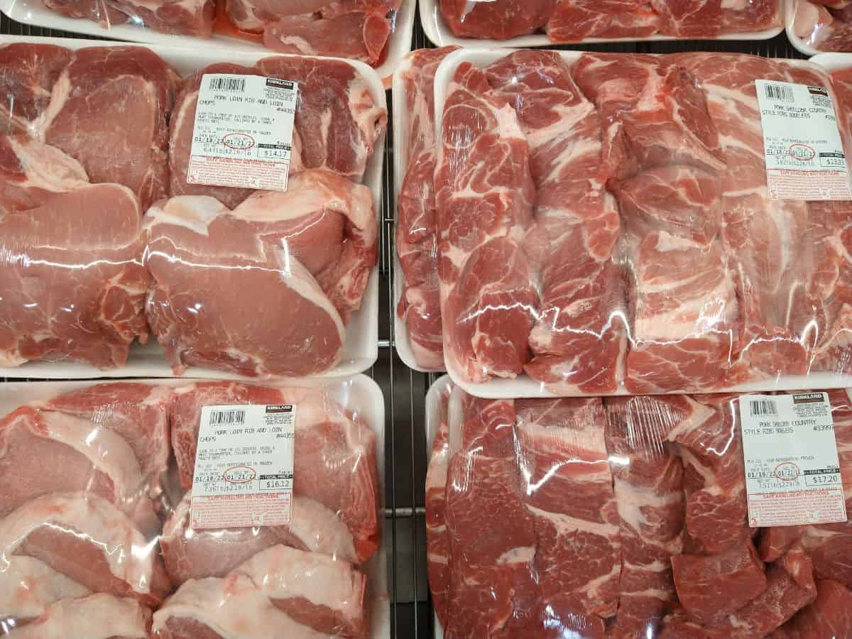 Pork chops on the left with St Louis pork ribs on the right on display at a Costco store in their packaging.