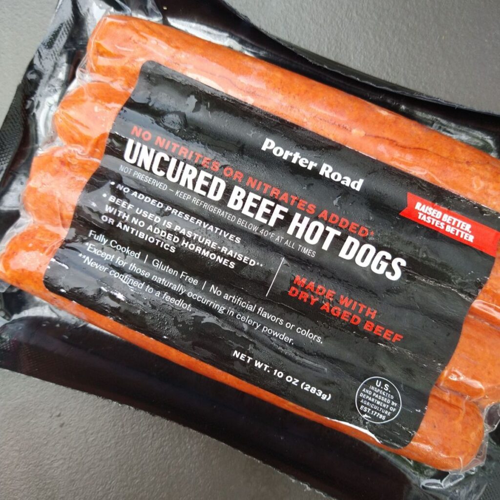 A package of 4 Porter road Uncured Dry Aged Beef Hot Dogs. 