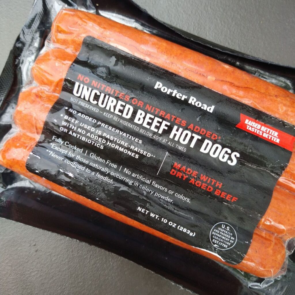 A package of 4 Porter road Uncured Dry Aged Beef Hot Dogs. 