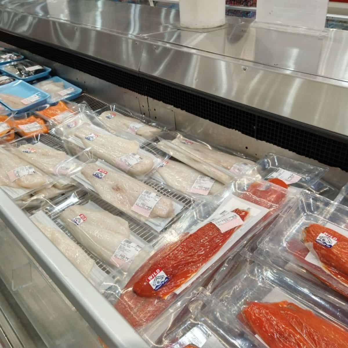 A display of different types of fresh fish at Costco.