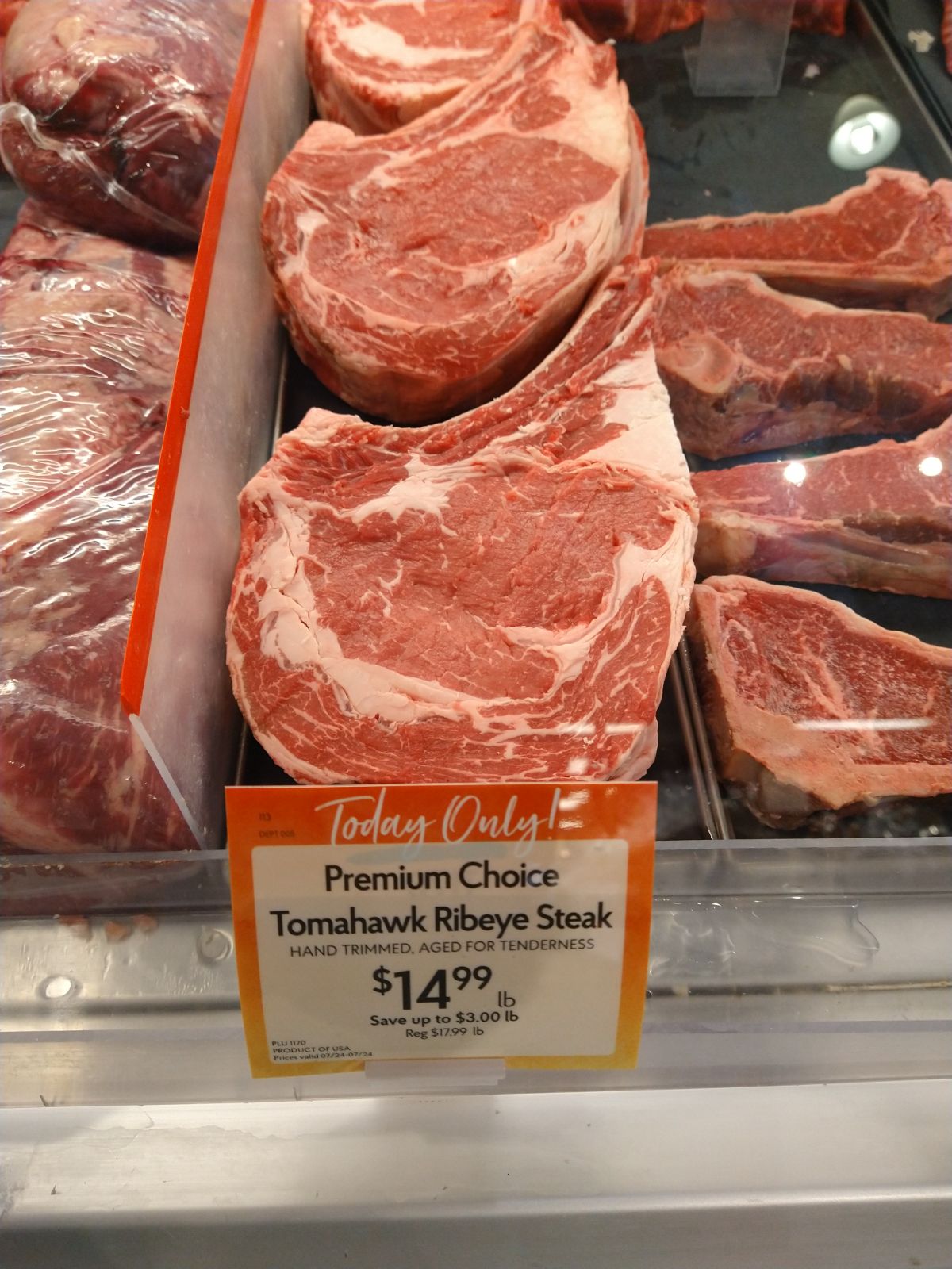 A beef display at a Fresh Market store with tomahawk ribeye steaks that are on sale for $14.99/lb.