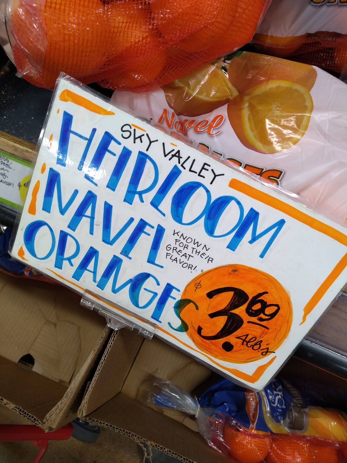 A sign at  Trader Joe's that says Sky Valley Heirloom Navel Oranges Known for their great flavor. $3.69 for a 4 lb bag.
