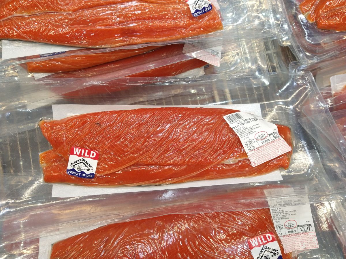 Vacuum sealed previous frozen wild sockeye salmon in a display case at Costco