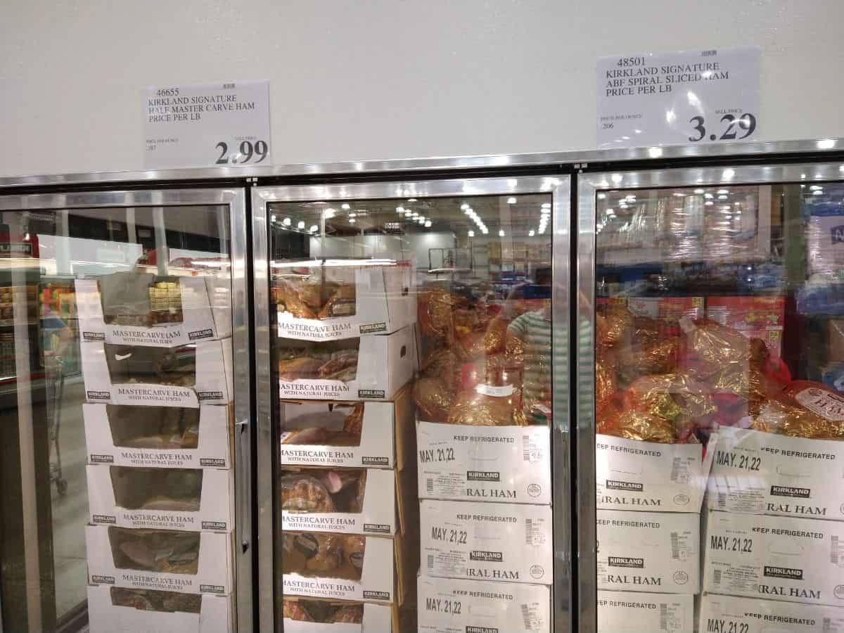 Hams in boxes in the refrigerated section of a Costco store. 