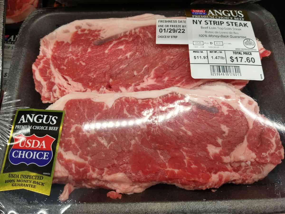 A package of two Angus USDA Choice New York strip steaks at the grocery store. The price is $11.97 a pound.