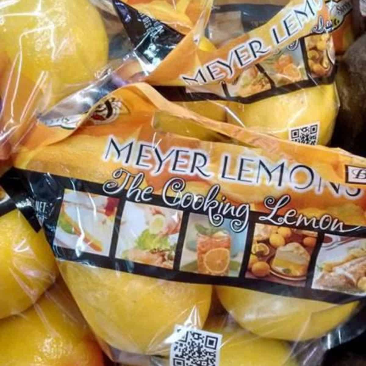 Bags of Meyer Lemons on display at a grocery store.