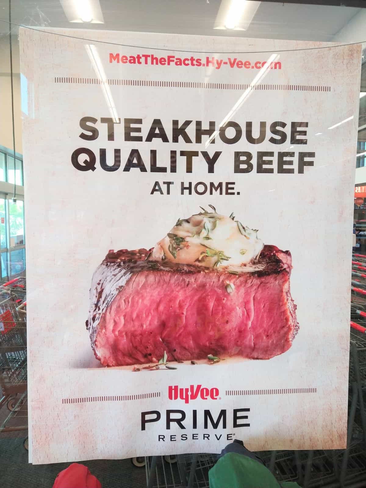 A sign at a Hy-Vee store showing a medium rare steak. The signs says "Steakhouse Quality Beef at Home" and "Rime Reserve" at the bottom.