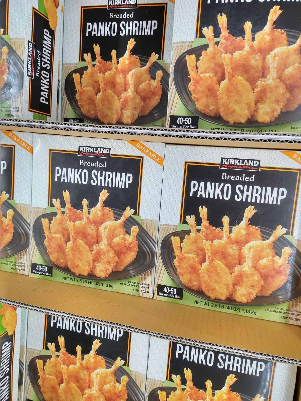 Boxes of Kirkland Brand Breaded Panko Shrimp in the frozen section at Costco.