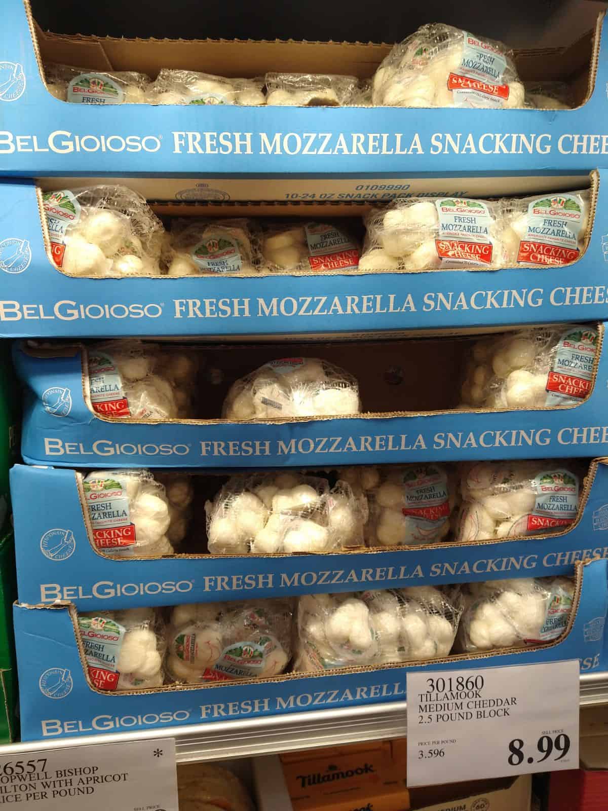 Blue boxes filled with bags of BelGioioso fresh mozzarella snacking cheese.