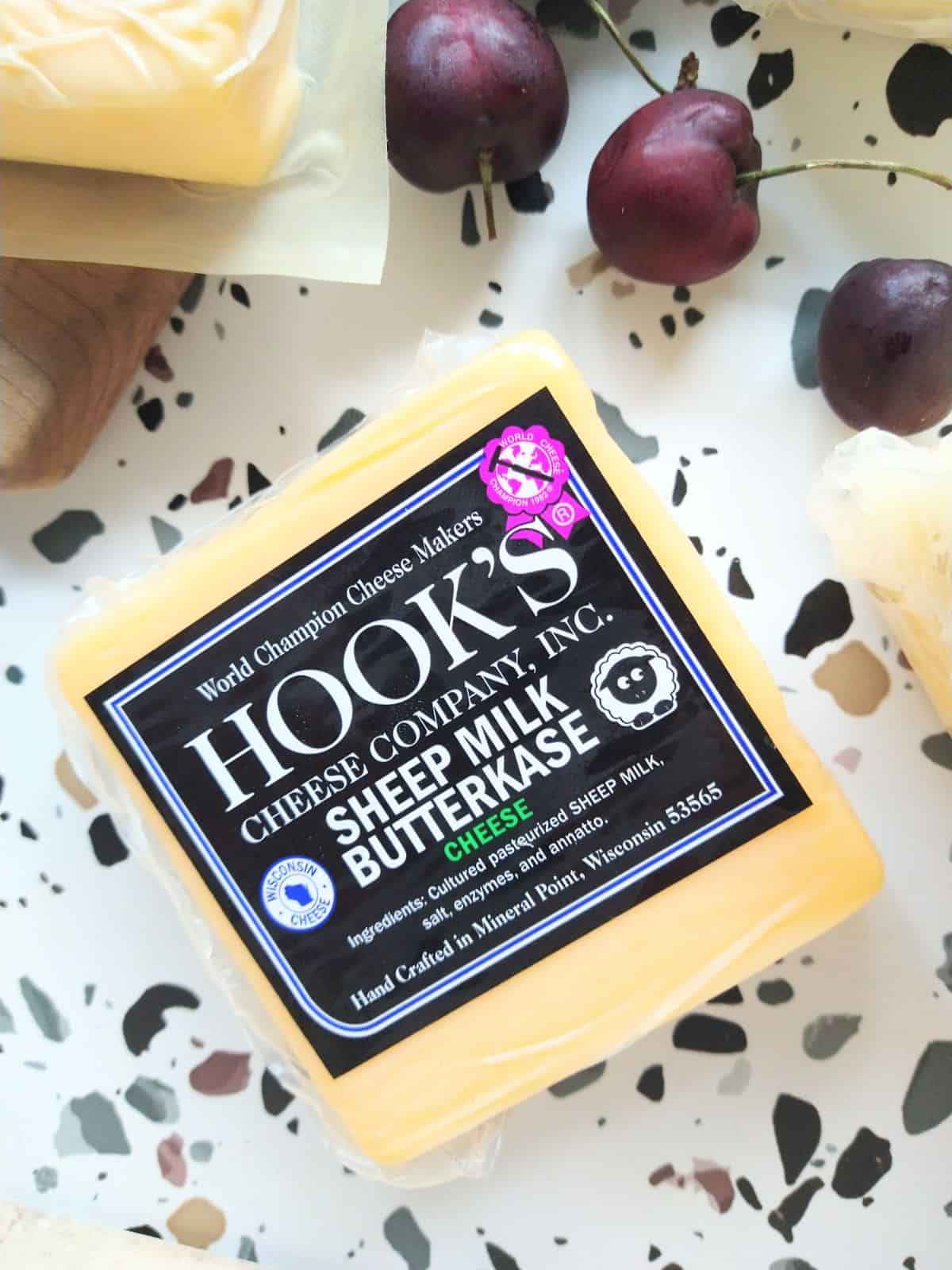 Hook's Sheep Milk Butterkase cheese sitting on a white table with spots.