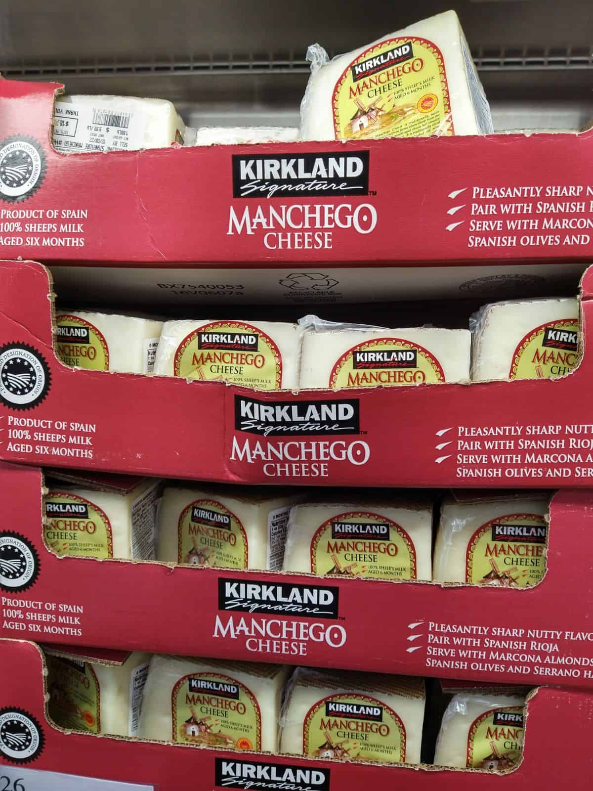 Red boxes filled with chunks of Kirkland Manchego cheese.