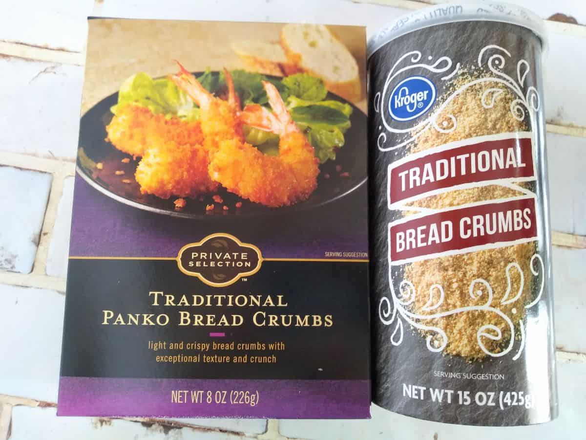 A box of Private selection Panko bread crumbs next to a canister of Kroger traditional read crumbs. Both are sitting on a white title countertop.