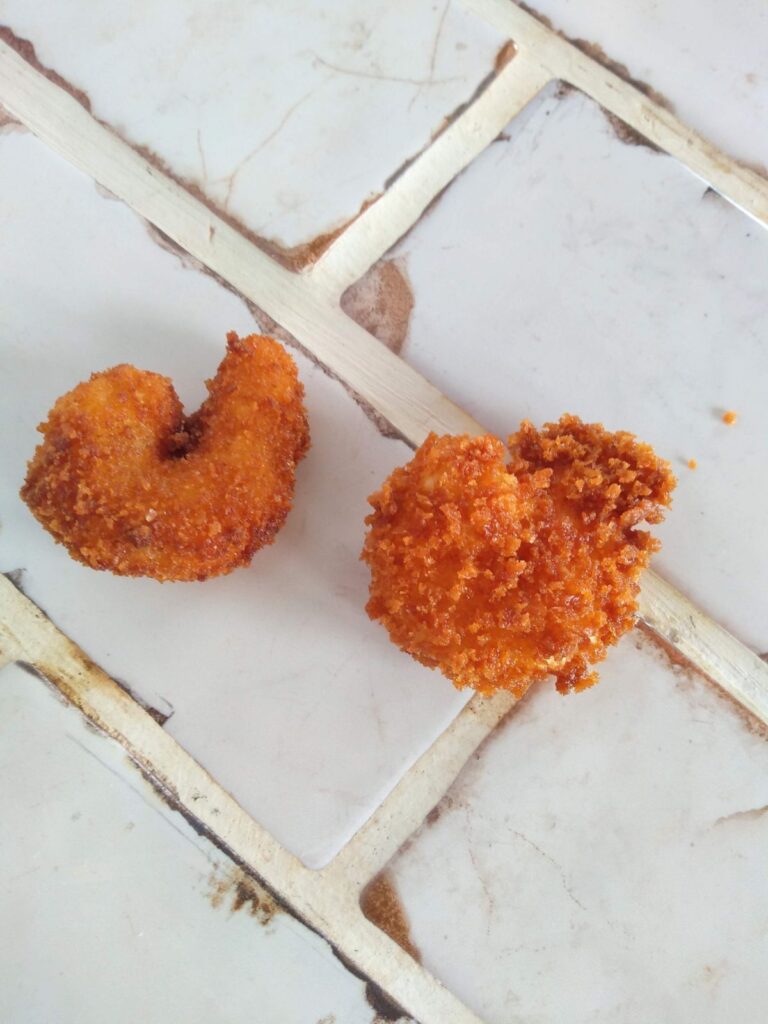 On the left is homemade fried shrimp that was breaded with traditional breadcrumbs and on the right is fried shrimp that is coated in Panko bread crumbs. The Panko coated shrimp appears more crispy with more visual crumbs than the traditional breadcrumbs. 