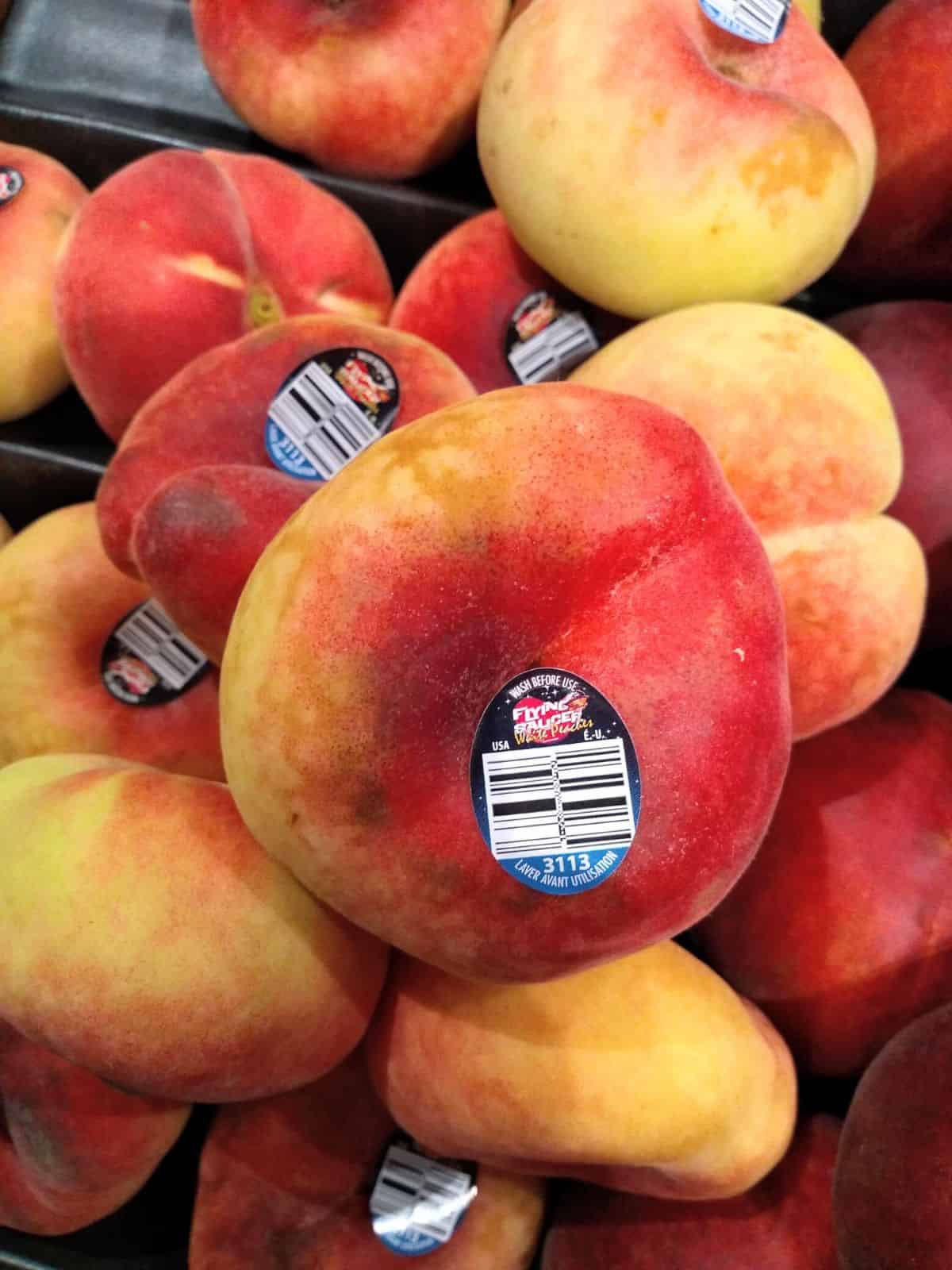 Flying Saucer branded white donut peaches on top of each other in the grocery store. 