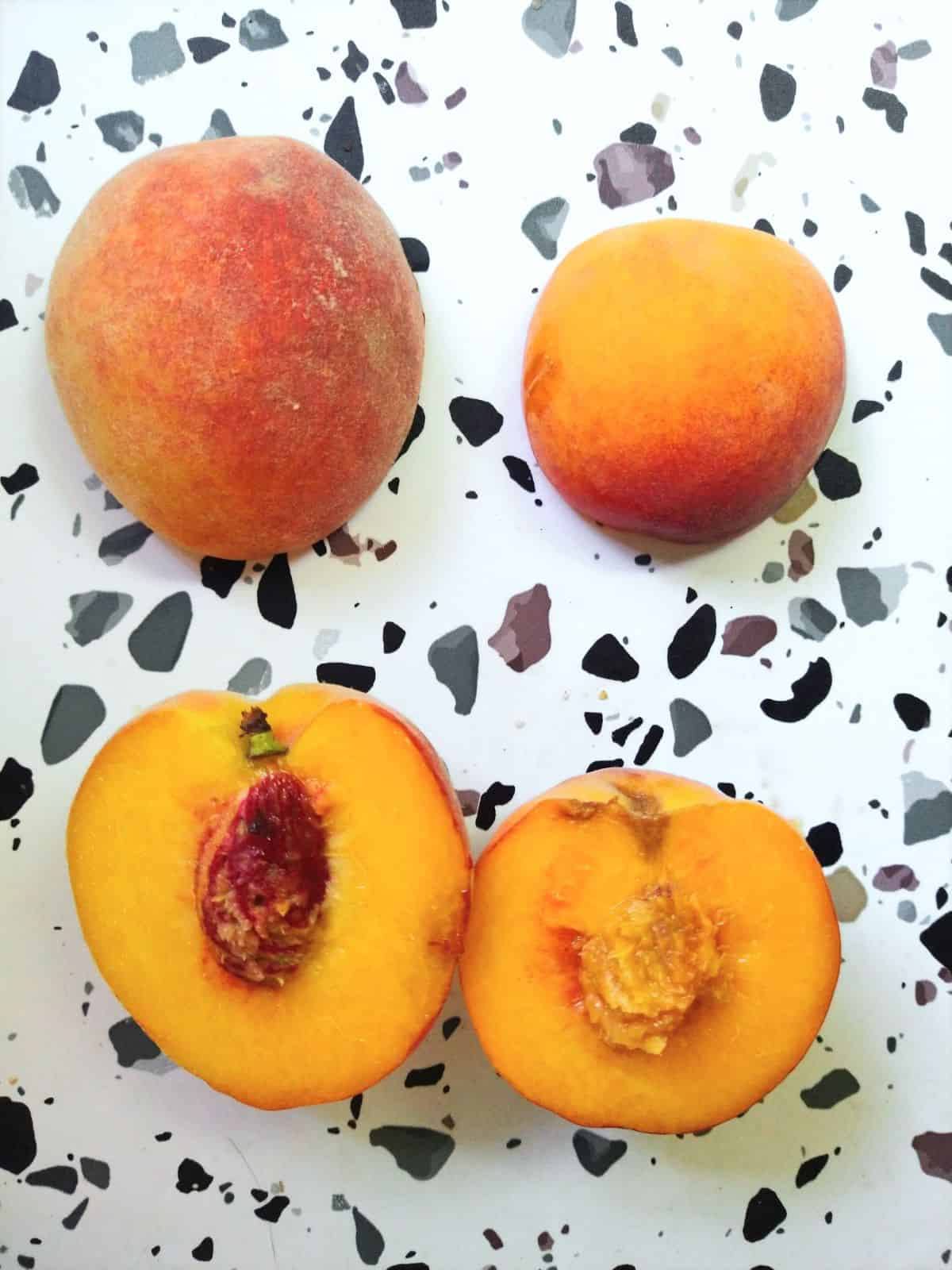 Freestone and clingstone peaches cut in half. 
