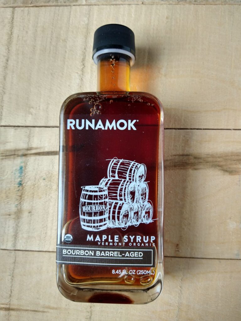 Runamok Bourbon barrel aged syrups on a wood board. 