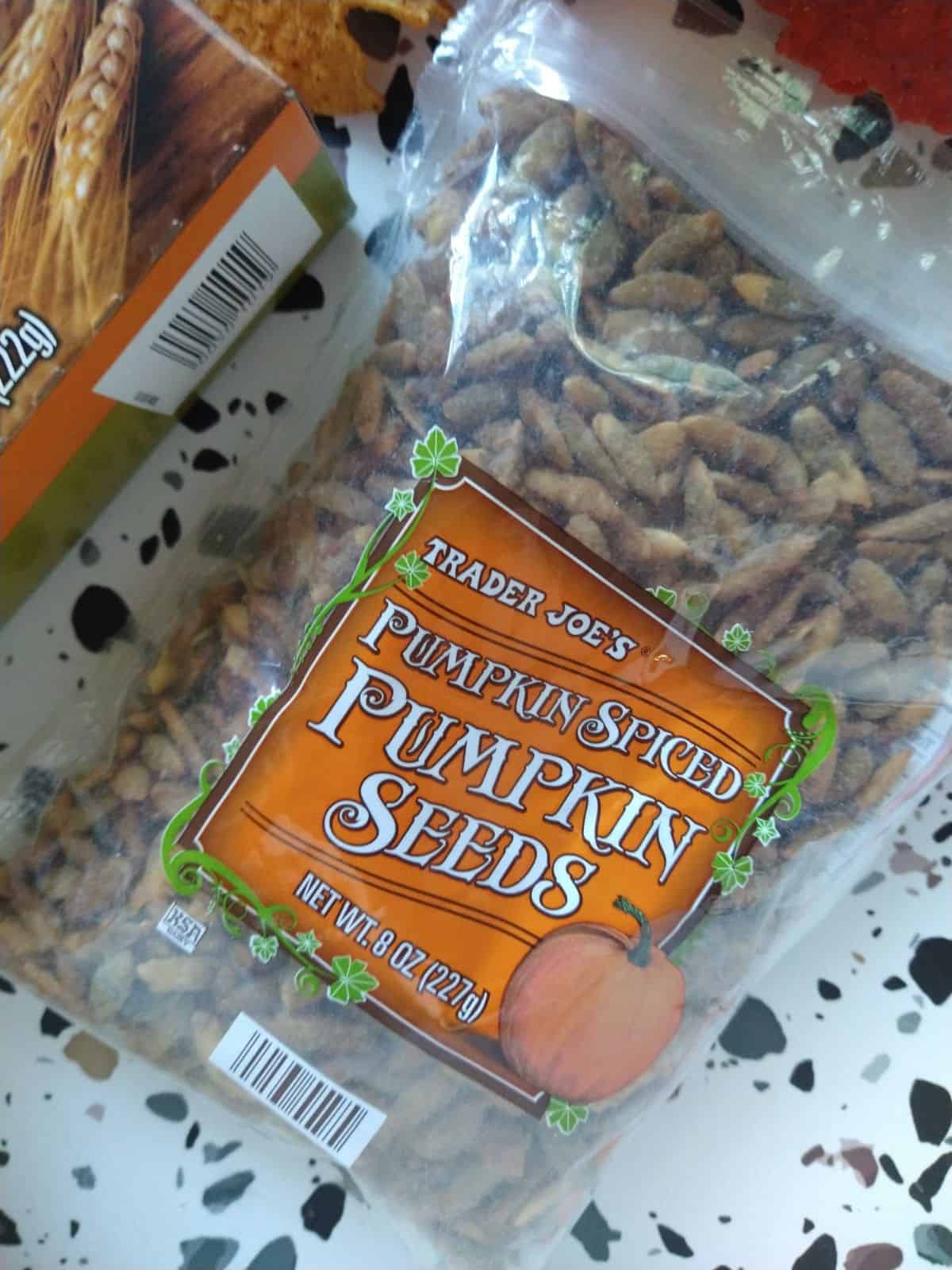 A close up of a clear bag of Trader Joe's Pumpkin Spiced Pumpkin Seeds.