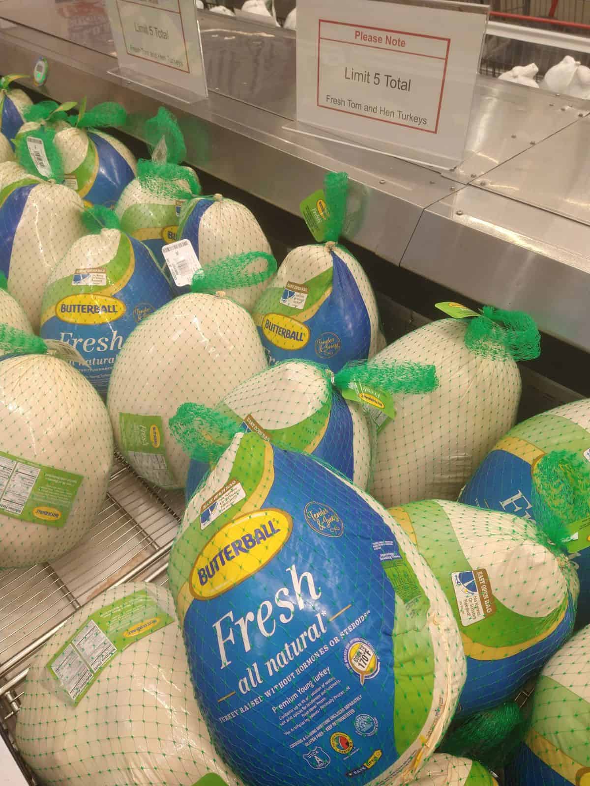 A display of Butterball fresh turkeys with a sign above them that says Limit 5 total. 