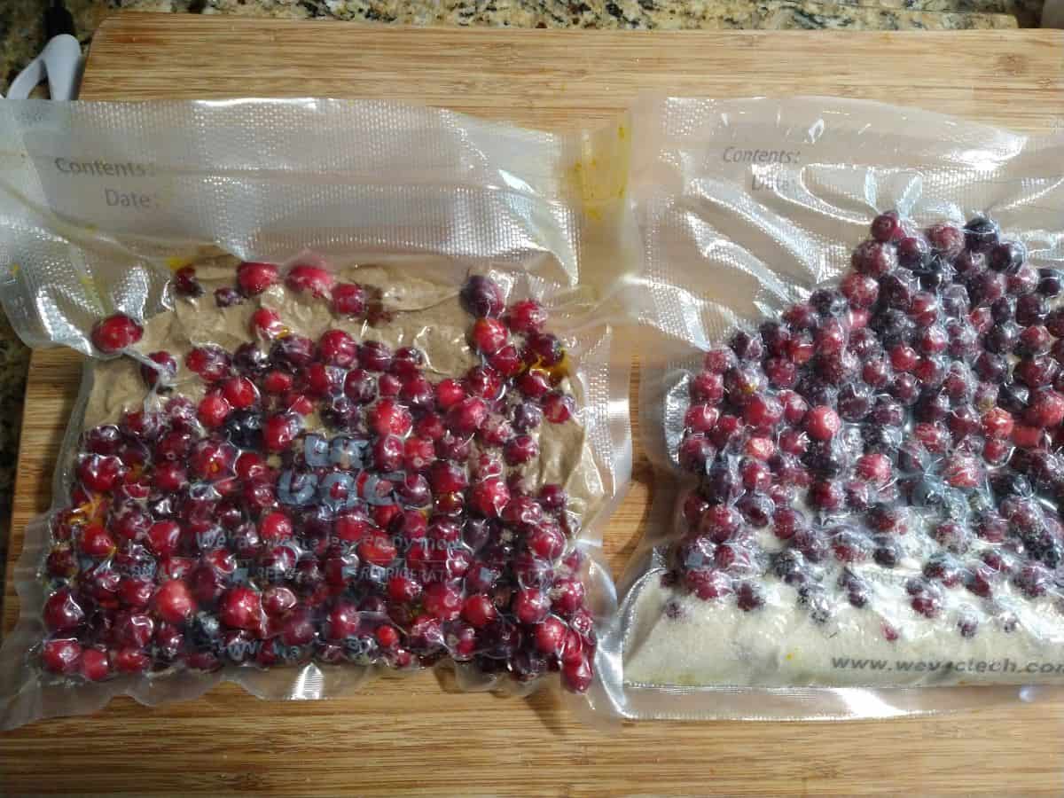 Bags of vacuum sealed cranberries. One bag with brown sugar and one with white sugar. 