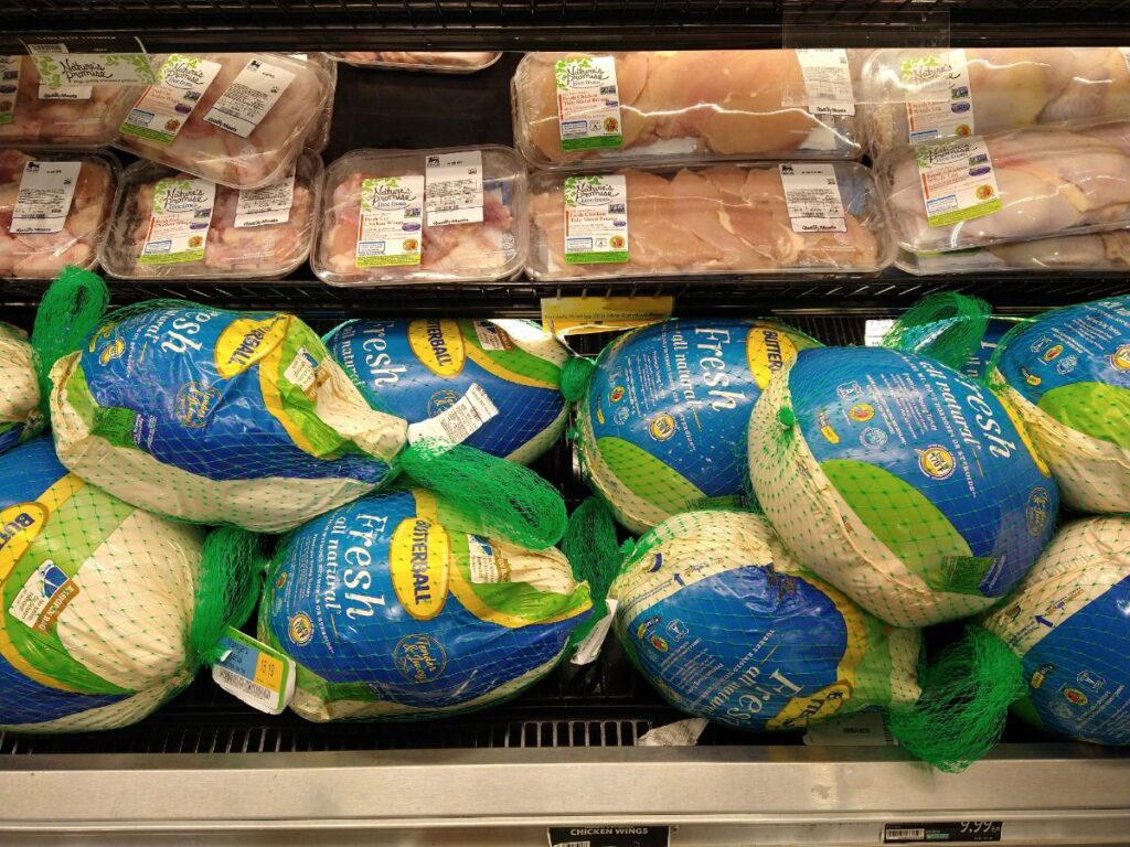 The remaining Fresh Butterball Turkeys underneath packaged chicken at a Food Lion store.