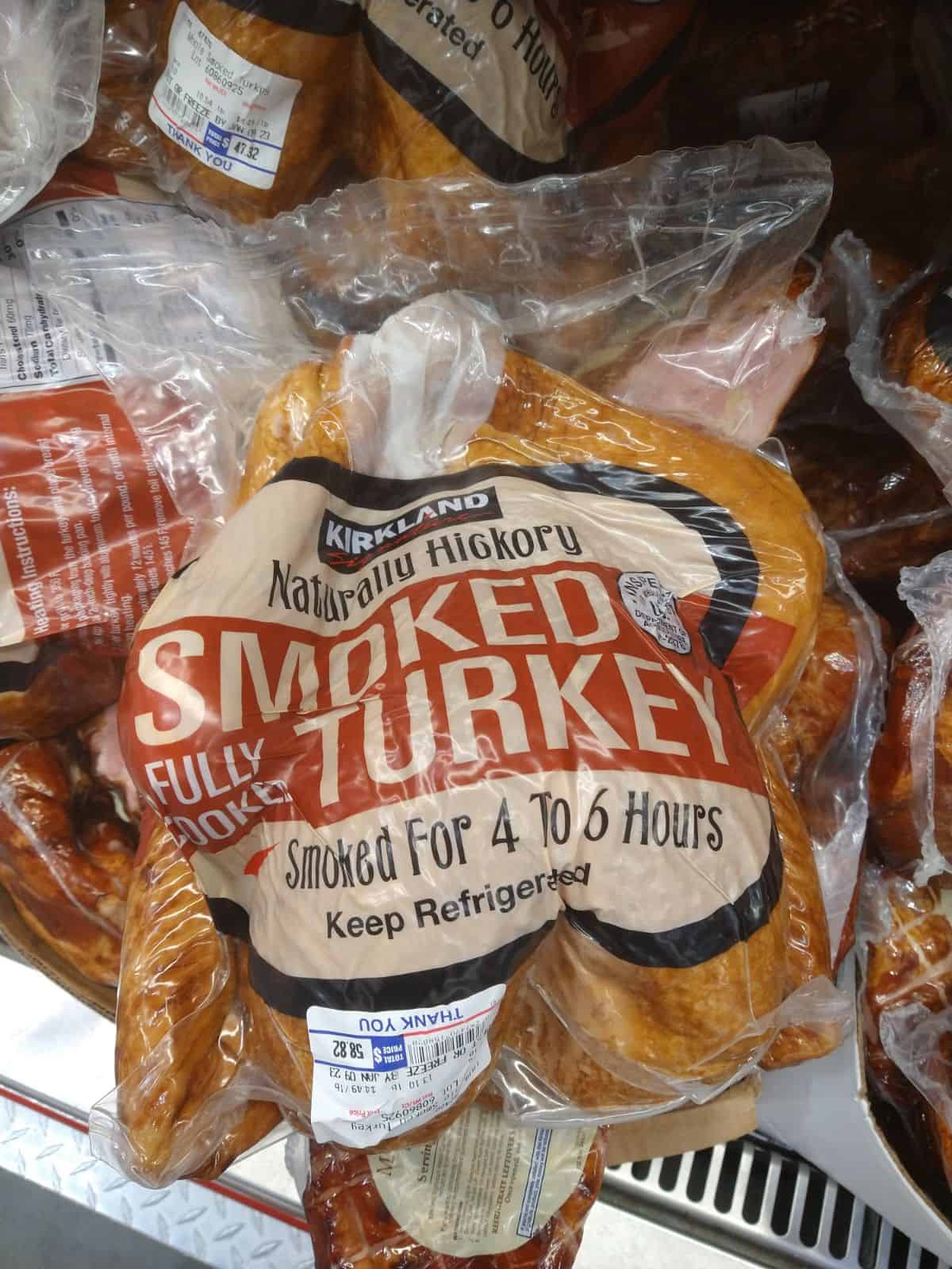 A display of vacuum sealed Kirkland Hickory Smoked Fully Cooked Turkeys. 