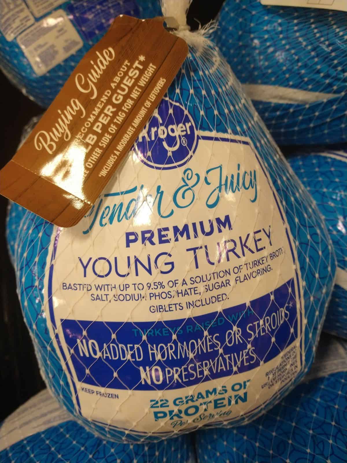 Kroger Tender and Juicy Frozen young turkey in blue and white packaging. 