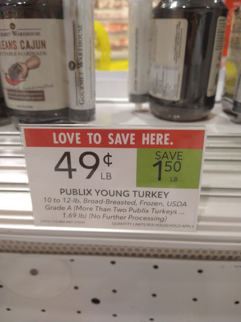 A sign that says Love to Save Here 49 cents a pound for Publix Young Turkey 10 to 12 lb Broad-Breasted Frozen.