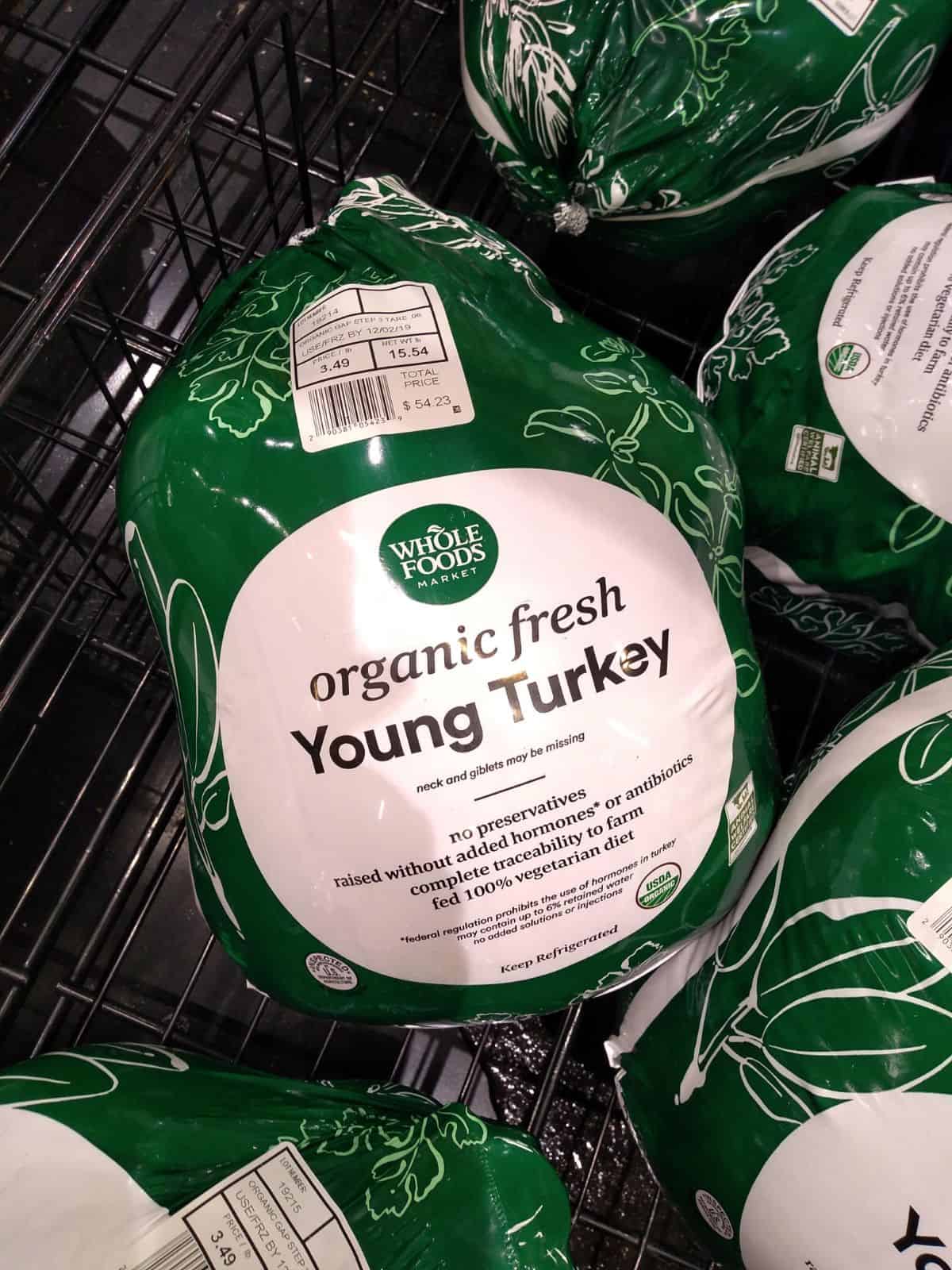 Whole Foods Market Organic Fresh Young Turkey in green and white packaging. 
