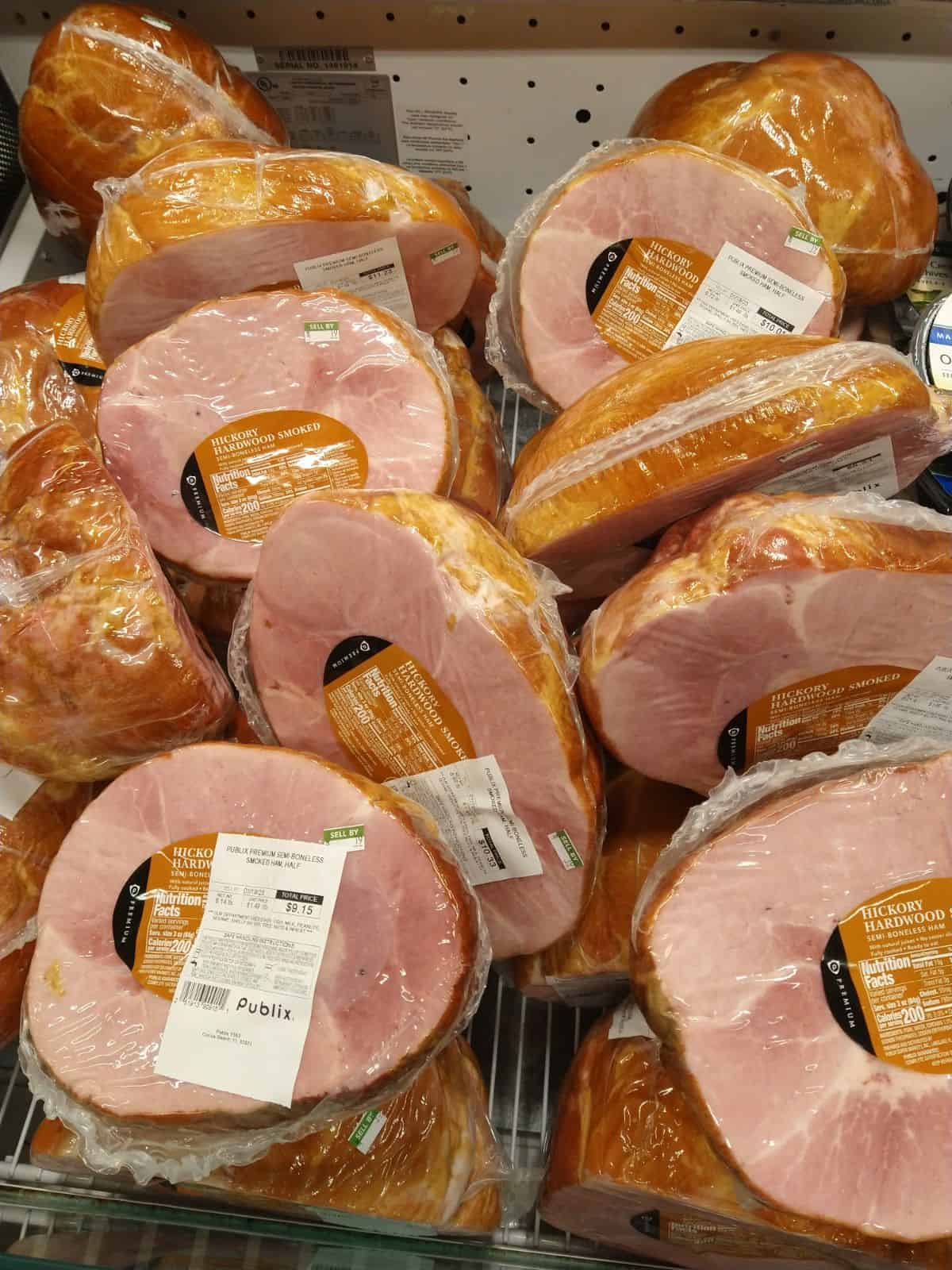 Publix brand Semi-boneless hickory smoked hams on display.