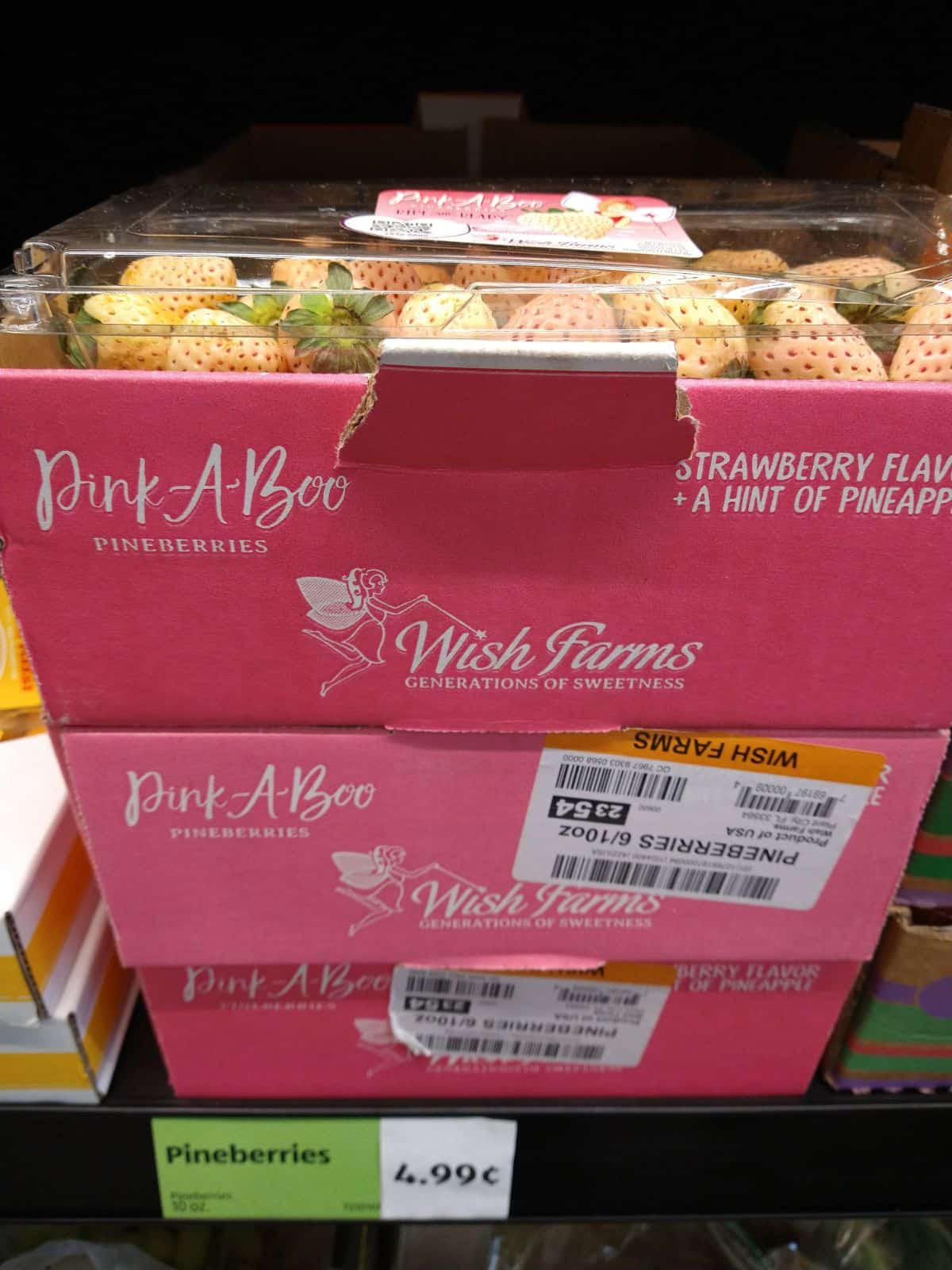 A display of boxes of pineberries from an ALDI. The price tag says they are $4.99 each.