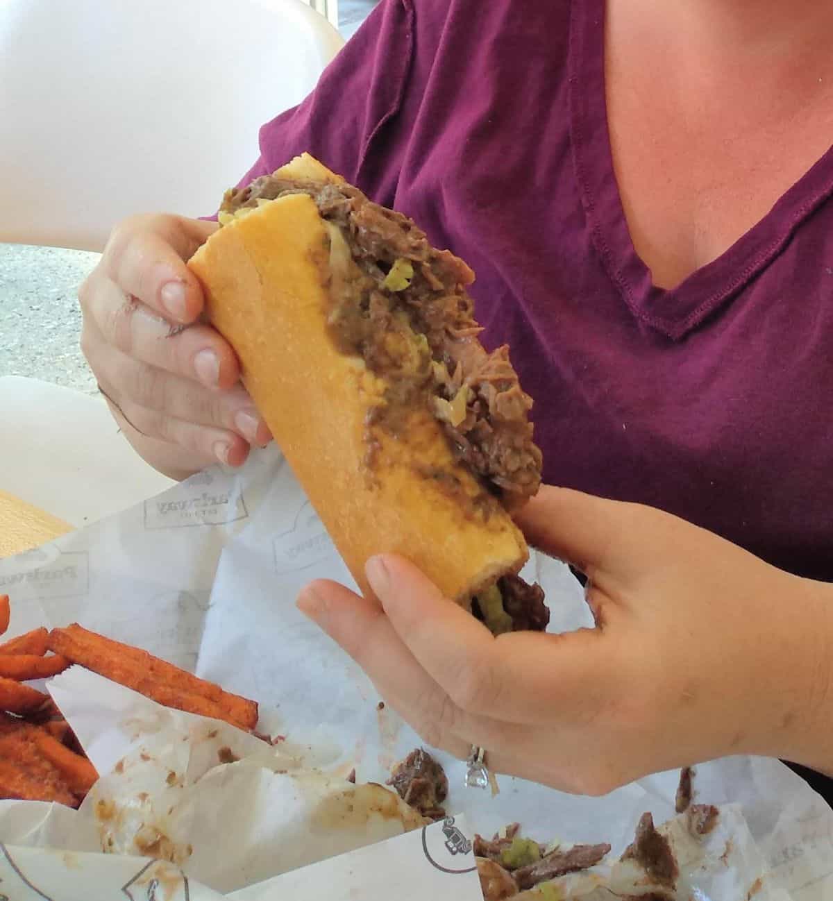 My wife holding roast beef po'boy sandwich from Parkway Bakery in New Orleans. 