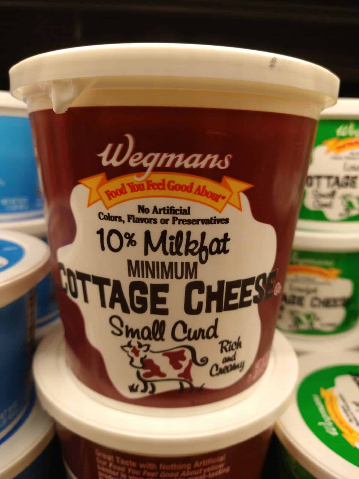 A container of Wegmans 10% milkfast cottage cheese on display.
