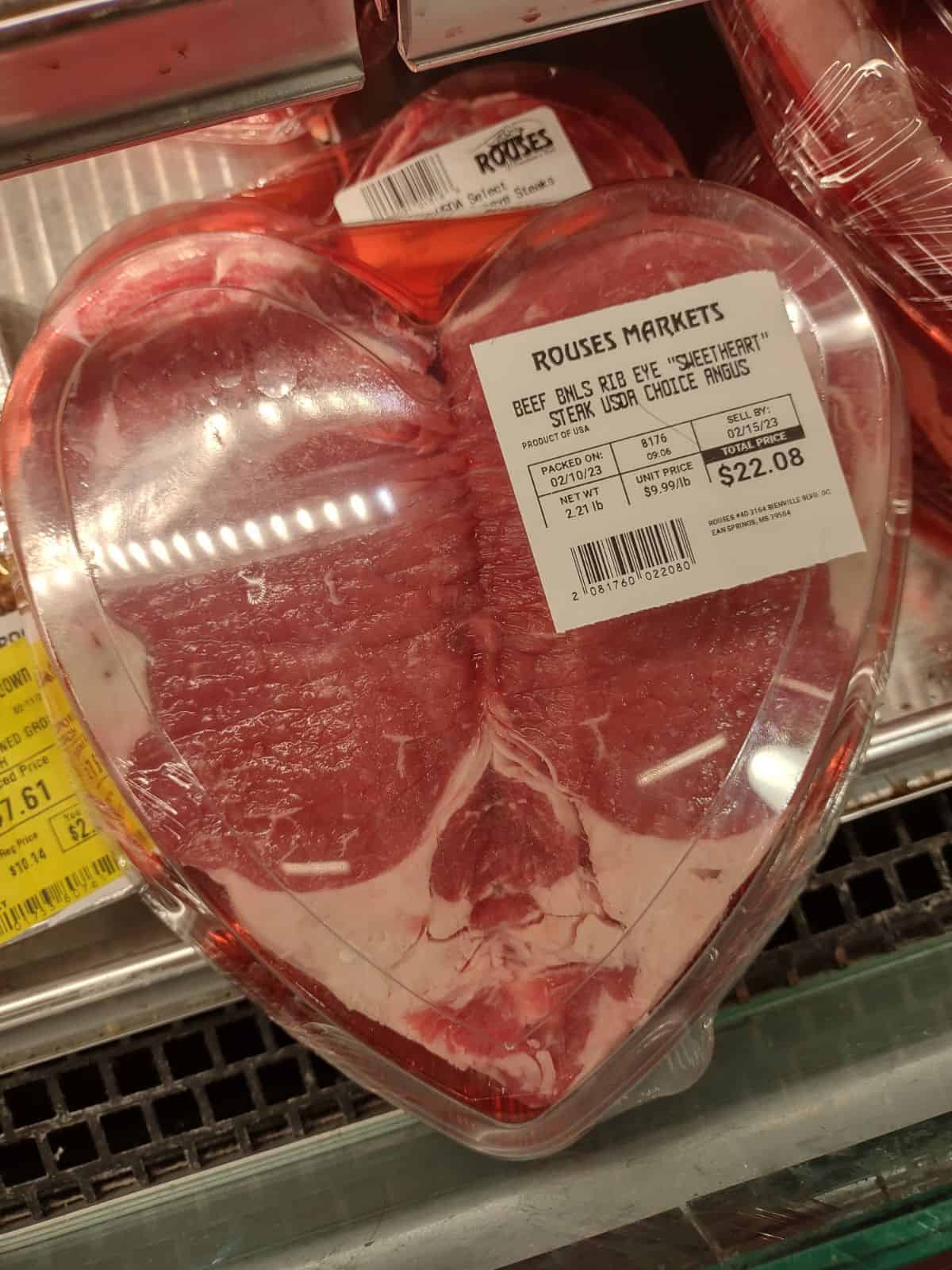 A sweetheart Ribeye steak from Rouses Market in a plastic heart shaped container. 