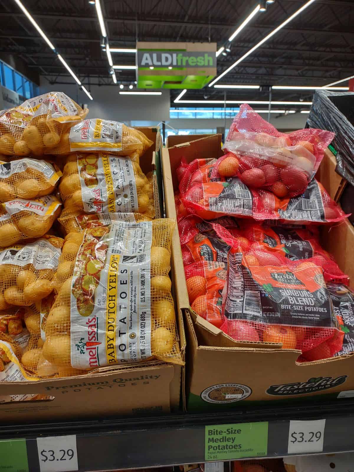 A display of boxes at ALDI filled with small bags of bite sized potatoes.