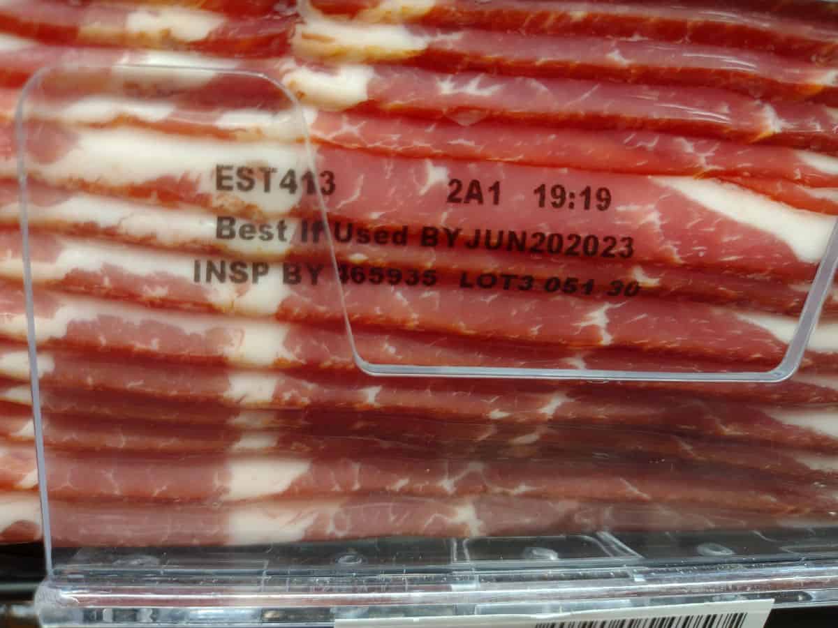 A vacuum sealed package of bacon with the best if used by date of June 20, 2023.