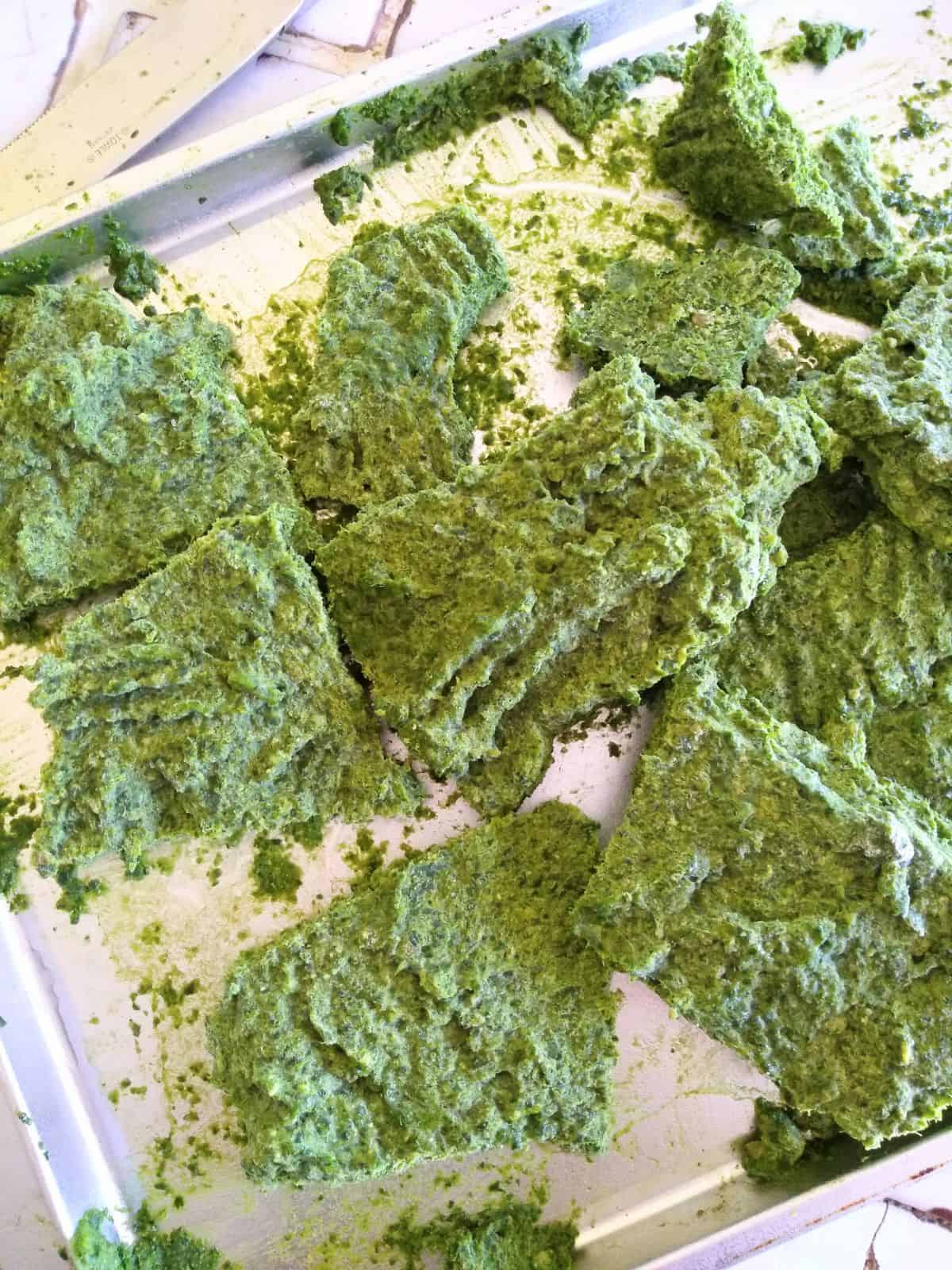 Frozen chunks of Pesto on a sheet pan.