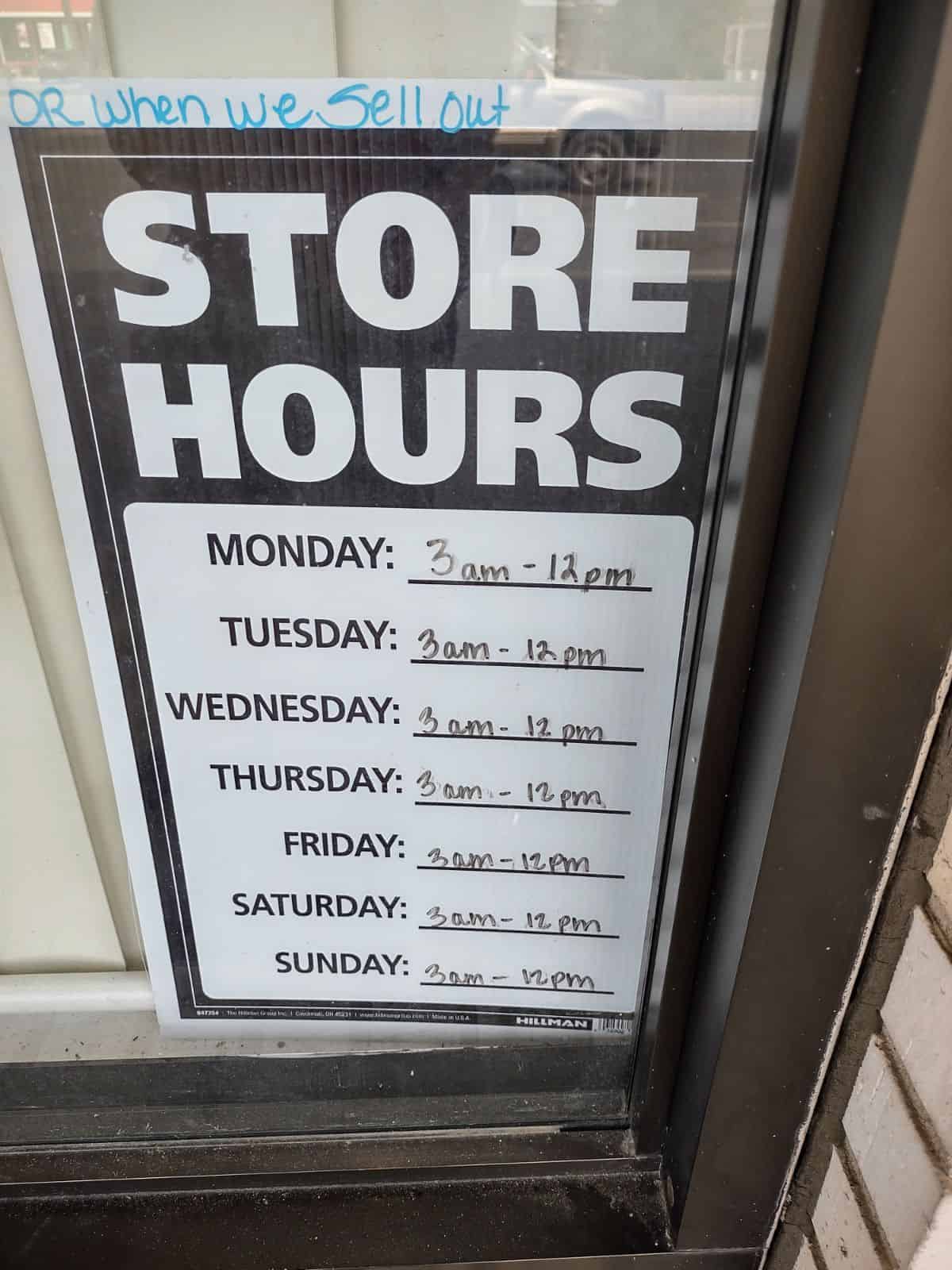 Store hour sign at a donut shop saying they are open from 3am-12pm or until they sell out.